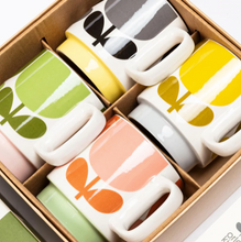 Load image into Gallery viewer, Featuring another one of her instantly recognizable designs, Block Flower, this set of 4 stacking  mugs in a jaunty colour combination are functional, affordable and very acceptable as a gift. Size 113x83x99mm.  
